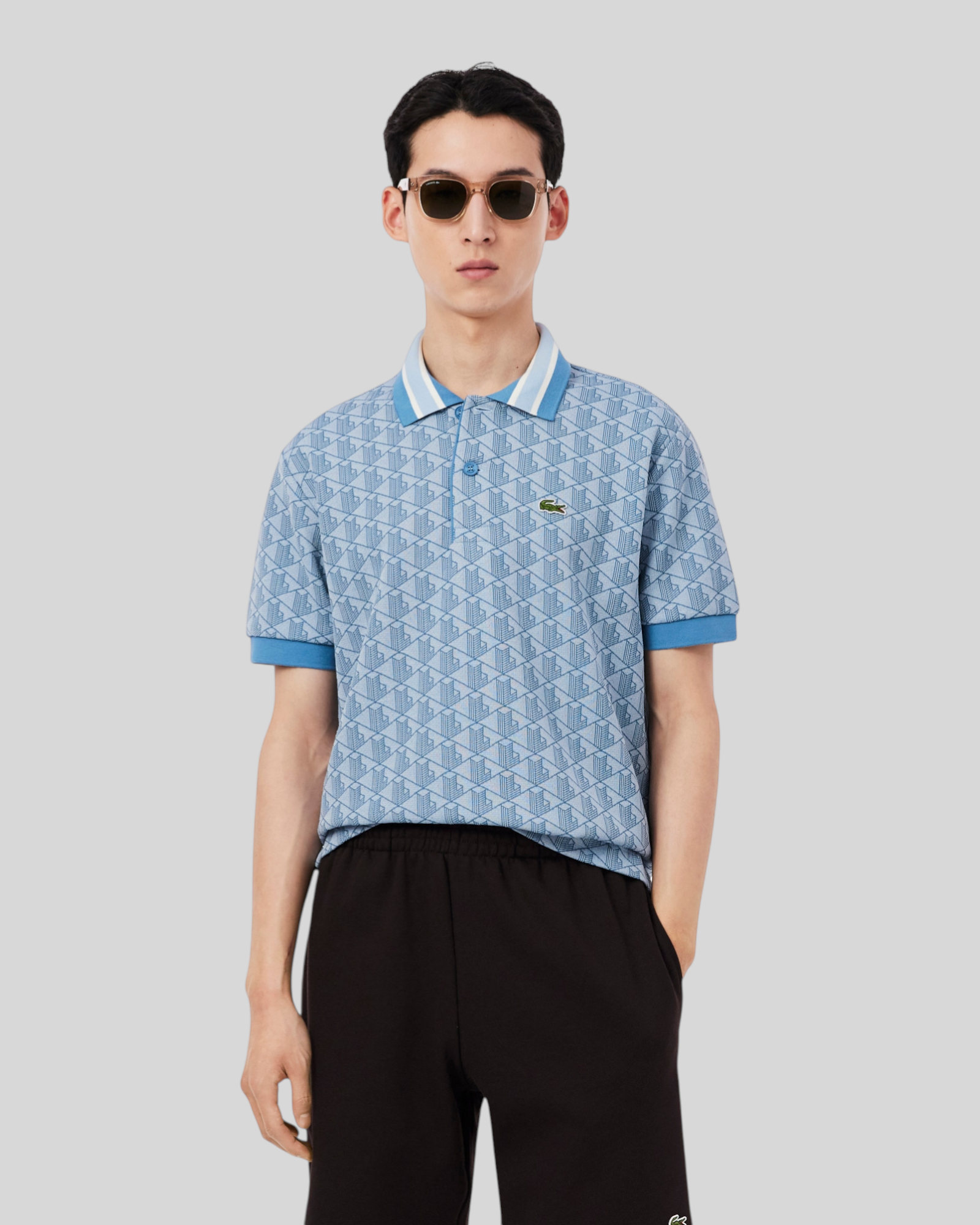 Brillantina Store light blue jacquard polo shirt with monogram pattern, contrast striped collar, and embroidered crocodile logo.